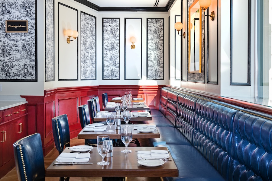 a row of two-person tables set for a meal in a bistro-style restaurant