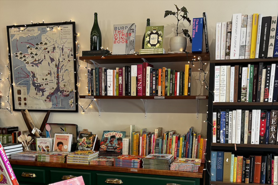 Bookstore display with various cookbooks and children's books on shelves.